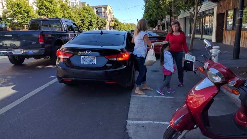 Just another Uber blocking the bike lane on Valencia. But according to a company message, now they can "choose" not to do this. Photo: Streetsblog/Rudick