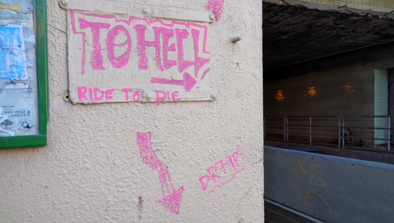 This graffiti at the entrance to the Posey Tube walkway still says it best. Photo: Streetsblog/Rudick