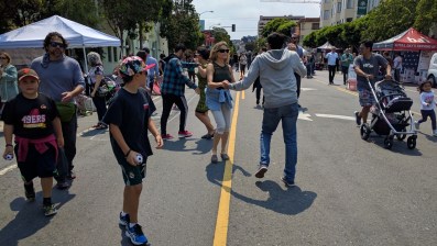 People dancing on the street during Sunday Streets in the Mission. Please donate to Streetsblog SF!