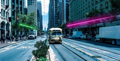Purple light shows a Muni subway heading inbound, while an M or (a Daly City BART train?) heads outbound...somewhere below. Image: Illuminate