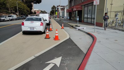 Dropping in some traffic cones helped stop motorists from parking on the Valencia protected bike lane. Photo: Streetsblog/Rudick