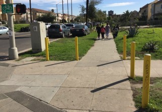 Anti-parking posts like these (which didn't prevent the car from its spot) are proliferating in Koreatown. All photos: Joe Linton/Streetsblog L.A.