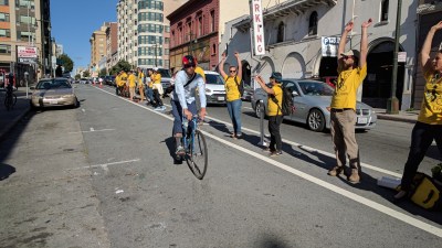 A cyclist greeted by a bike lane protected by humans on Golden Gate. All Photos Streetsblog/Rudick