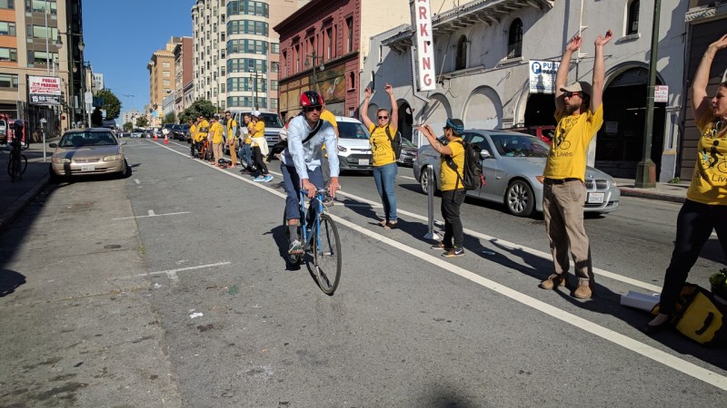 A cyclist greeted by a bike lane protected by humans on Golden Gate. All Photos Streetsblog/Rudick