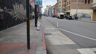 SF Transformation has installed about 200 feet of bollard protected bike lane on Turk near Market. Photo: Streetsblog/Rudick