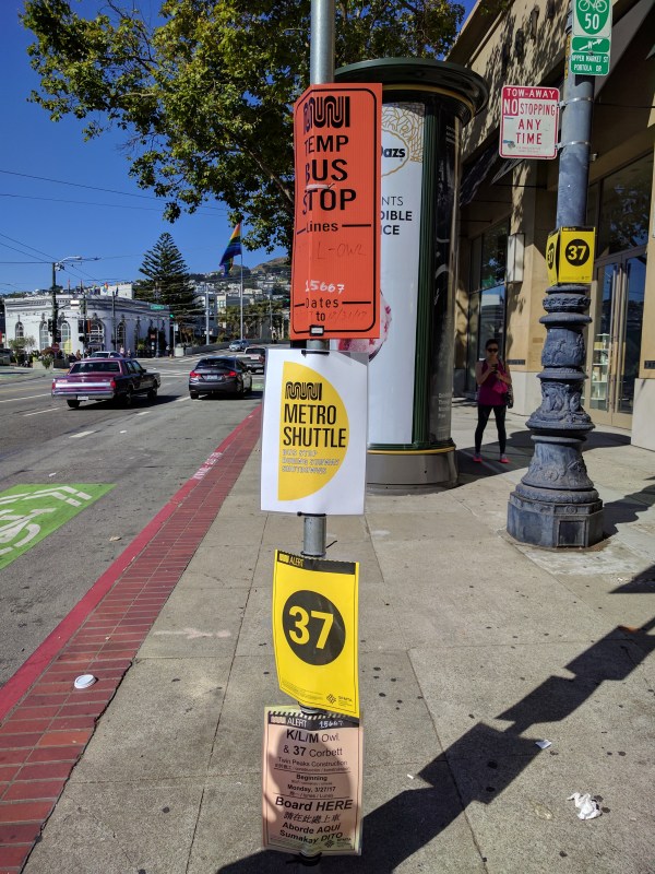 Imagine a tourist trying to decipher this mishmash of signs at the temporary bus stop from Castro to West Portal. How about one really big sign that says: "Catch Subway Replacement Bus Here." Photo: Streetsblog/Rudick