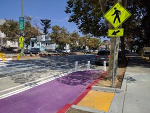 Purple paint and a new curb cut help people navigate around the tree at the 23rd/Harrison crosswalk. All photos Rudick/Streetsblog unless otherwise noted.