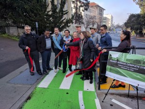 Mayor Jesse Arreguin, flanked by other county and city officials, cutting the ribbon on the new Hearst Avenue protected bike lane. Photo: Streetsblog/Rudick