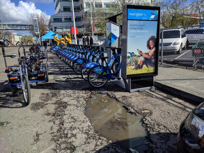 One of two bike-share stations installed in Jack London Square yesterday. Pot hole courtesy of the City of Oakland. All photos Streetsblog/Rudick unless noted.