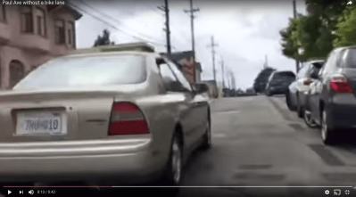 A still from Chris Waddling's morning commute on Paul Avenue in the Bayview, with the bike lane removed, parking restored, and a car passing within three feet. Image: Chris Waddling