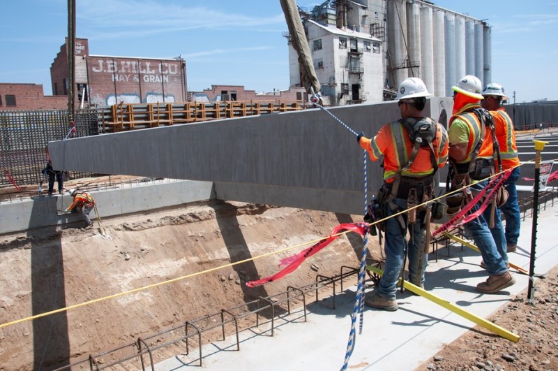 Workers offloading girders for HSR's Fresno trench. Photo: CAHSRA