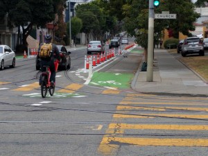 A cyclist entering the newly upgraded, curb-protected bike lane on 17th between Church and Sanchez. All pics Streetsblog/Rudick unless noted