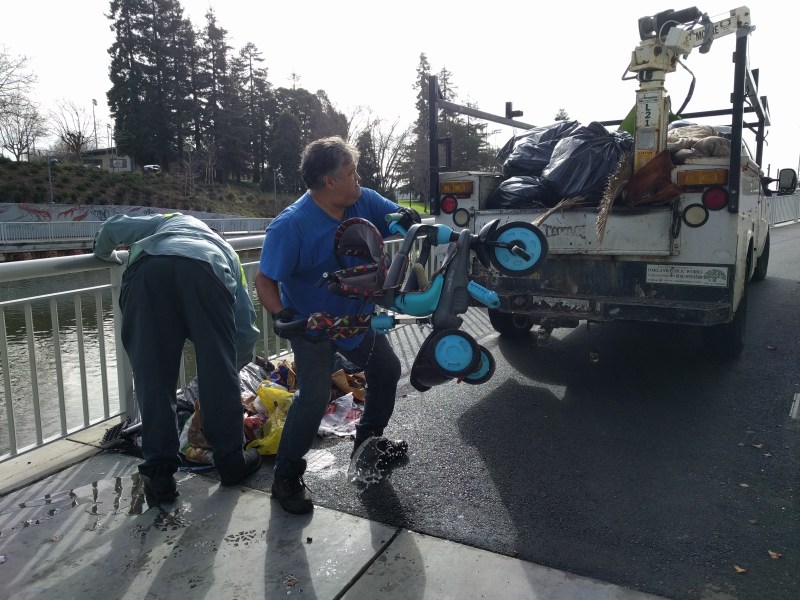 Oakland Public Works busy cleaning up the channel path. Thank you! Let's hope this little blue tricycle will go back to its owner or to a child in need. Photo: Streetsblog/Rudick