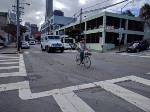 A cyclist navigates the intersection of Sansome and Vallejo. Note the three-level parking structure. Photo: Streetsblog/Rudick