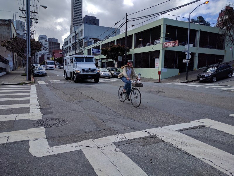 A cyclist navigates the intersection of Sansome and Vallejo. Note the three-level parking structure. Photo: Streetsblog/Rudick