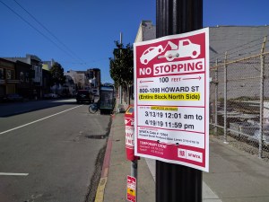SFMTA's Rapid Response team has put up "no stopping" signs on Howard and bagged the parking meters. Note the black SUV driving half in the bike lane up ahead. Photos: Streetsblog/Rudick
