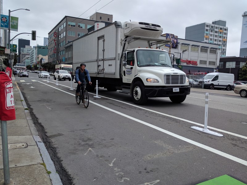 A cyclist passing a truck near the spot where Tess Rothestein was killed. Photo: Streetsblog/Rudick