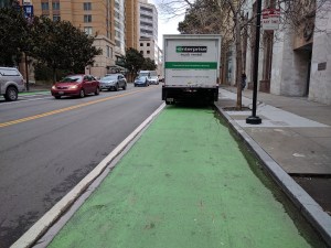 Green paint, raised curb, no protection = no safety for cyclists. The scene this morning on 2nd. Photos: Streetsblog/Rudick unless indicated