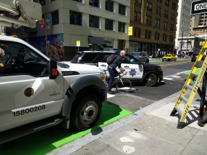 The city truck parked on the bike lane and an SFPD cruiser making a dangerous, un-signaled turn on a typical day in 2019 of city employees driving recklessly. Photo: Streetsblog/Rudick