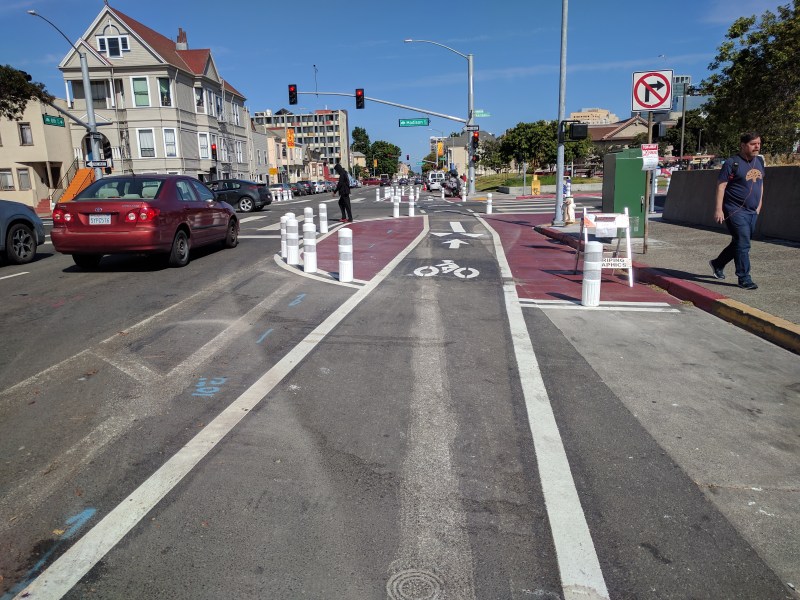 One of Oakland's new low-cost protected intersections around Lake Merritt BART, complete now with K71 bollards. Bollards keep people from parking on the corner AND make it safer for cyclists