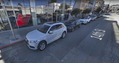 S.F. Audi continues to illegally park cars in the red zone--blocking sightlines at the intersection of 14th and S. Van Ness--with total impunity. Image: Google Earth