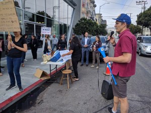 Advocate Taylor Ahlgren leading Saturday's protest against Audi of San Francisco. Photo: Streetsblog/Rudick