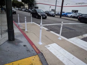 Paint and safe hit posts have made it clearer to Audi that they can't leave cars in the red zone. Photos: Streetsblog/Rudick unless indicated