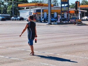 A pedestrian crosses out of Chicago at Harlem, the edge of the city. (Chicagoland Bike & Walk Photo Contest)