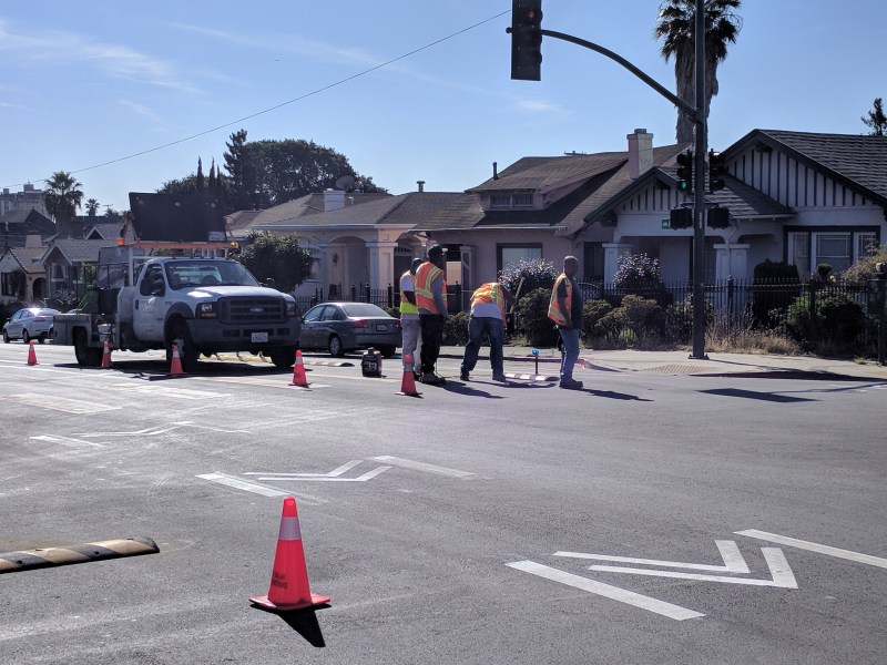 OakDOT crews working on a "centerline" safety treatment at 22nd and Foothill, site of a deadly crash earlier this month. Photos: Streetsblog/Rudick