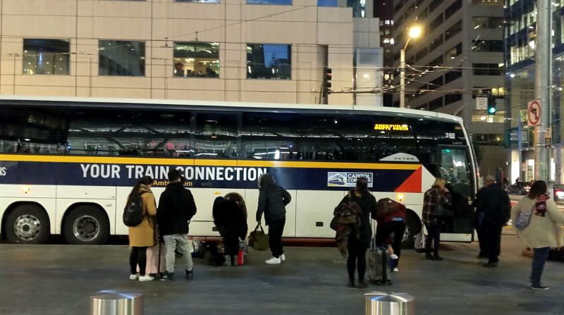 An Amtrak bus picking up passengers at a Muni stop at Mission and Fremont, outside of the Salesforce Transit Center. Photo: Parker Day