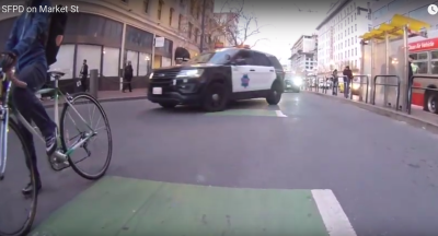 The driver of this police cruiser got on his PA and informed cyclists who were slowing his progress that "there's a bicycle lane for a reason." Image from Jessica Jenkin's YouTube.