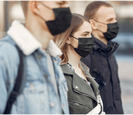 These people should be standing further apart — but their risk of COVID-19 transmission is still probably lower than if they were doing the same thing indoors. Source: Creative Commons.