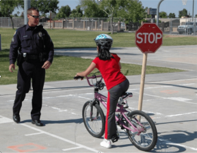 Yes, that *is* an armed law enforcement officer standing mere feet from a child on a bike. Source: NHTSA