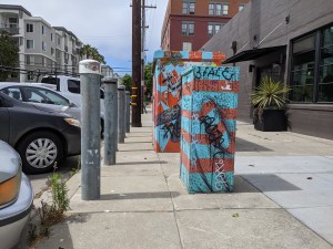 Steel posts line the sidewalk to protect these utility boxes in Oakland. Photos: Streetsblog/Rudick