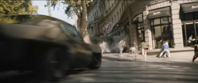 Pedestrians flee aggressive driver hurtling through crosswalk, but it's okay because justice. Still from trailer.