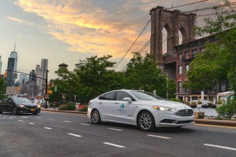 A self-driving vehicle from Mobileye’s autonomous test fleet sits parked in front of the Manhattan Bridge in June 2021. Mobileye tests its technology in complex urban areas in preparation for future driverless services. (Credit: Mobileye, an Intel Company)