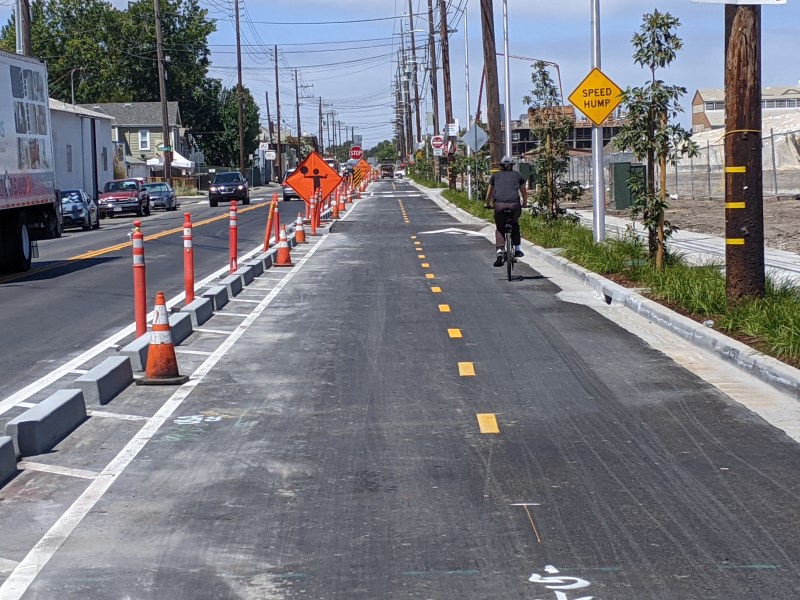 A cyclist on Clement Ave. in Alameda enjoying the protection of these new "chonky curbs." Photos: Streetsblog/Rudick