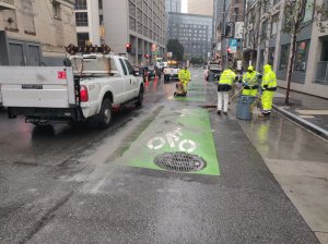 Crews removing the current "mixing zone" near where a pedestrian was killed in May. Photo: SFMTA