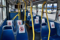 Interior of a TriMet bus (in the Portland, Oregon, metropolitan area) with numerous seats marked by "Don't sit here" signs intended to encourage spatial-distancing (in accordance with a temporary 10-passenger limit for buses) during the Covid-19 pandemic. Image: Steve Morgan, CC