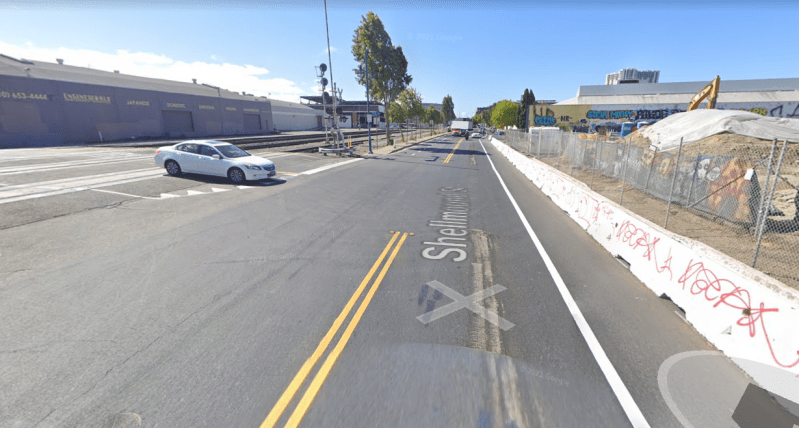 A sidewalk-level protected bike lane will eventually be built to the right of that barricade. Photo: Google Streetview