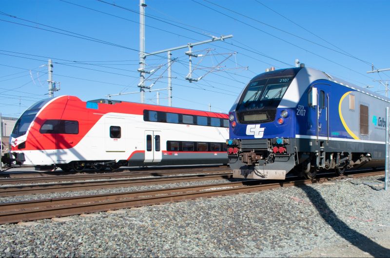 A new Capitol Corridor Amtrak locomotive next to a new Caltrain train set in San Jose. They run on the same tracks and serve stations in common, but the services accept completely different tickets. Photo: CV Makhijani
