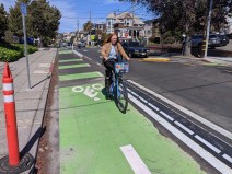 A cyclist on Milvia going past a section of new rubber, mountable curb. Photos: Streetsblog/Rudick
