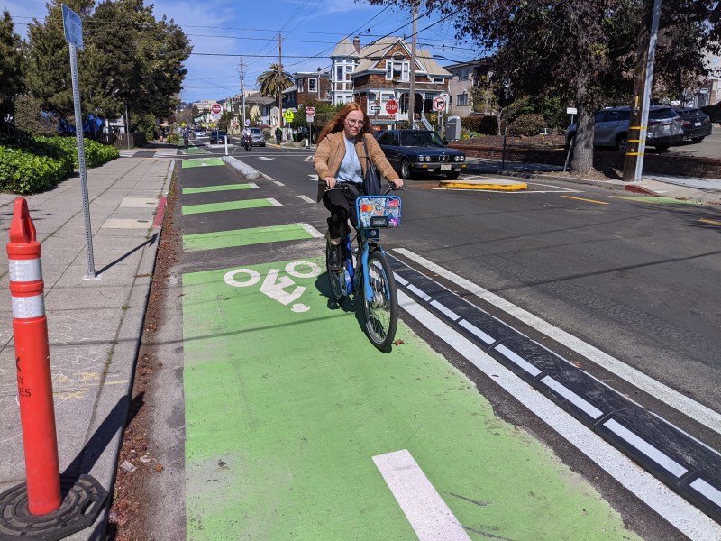 A cyclist on Milvia going past a section of new rubber, mountable curb. Photos: Streetsblog/Rudick