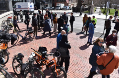 Advocates gather in front of the State House with their e-bikes on Wednesday, March 30, 2022.