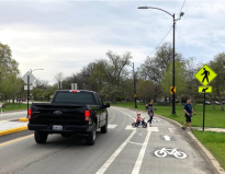 The driver of a monster pickup truck stops for a family using one of the new pedestrian islands in Columbus Park. Photo: John Greenfield