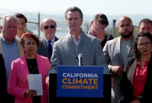 Governor Newsom surrounded by California state legislators